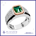 A platinum ring with a large emerald-cut green gemstone, a rose gold octagonal bezel, and diamond-set side panels on a white background with the Platiszem brand logo.