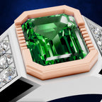 An octagonal emerald-cut green gemstone ring set in a rose gold bezel with a white band accented by clear stones, shown against a dark blue background.
