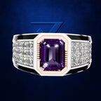 A men's statement ring featuring a large emerald-cut purple amethyst center stone, flanked by rows of clear pavé diamonds on a silver-toned band with black accents and a rose gold inner plating, set against a dark blue textured background.