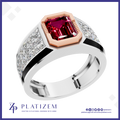 A platinum ring with a large emerald-cut pink gemstone in a rose gold bezel, flanked by pavé-set clear stones on a white band, shown on a white background with the Platiszem brand logo.