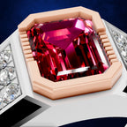 An octagonal ring featuring a large emerald-cut magenta-pink gemstone in a rose gold setting, flanked by rows of small clear accent stones on a white band, shown against a dark blue background.