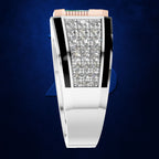 A white gold or platinum bangle watch with a rectangular bezel set with clear pavé diamonds, flanked by black inlays and a pink crown, shown against a dark blue textured background.