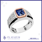 A men's statement ring by Platinzem, featuring a large emerald-cut blue sapphire center stone, a rose gold octagonal crown, and a silver-toned band paved with small clear stones.