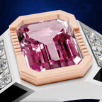 A close-up of a ring featuring a large, faceted pink gemstone in an octagonal rose gold setting, flanked by rows of small clear stones on a white band, set against a dark blue background.