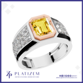A platinum ring featuring a central yellow emerald-cut diamond surrounded by a rose gold octagonal bezel, with diamond-set shoulders and a polished silver band. The brand logo 'PLATIZEM' is visible at the bottom.