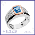 A platinum ring featuring a large emerald-cut blue topaz center stone, a rose gold octagonal bezel, and diamond-set shoulders, shown on a white background with the Platzem brand logo at the bottom.