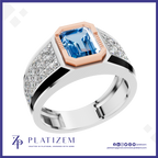 A platinum ring featuring a large emerald-cut blue topaz center stone, a rose gold octagonal bezel, and diamond-set shoulders, shown on a white background with the Platzem brand logo at the bottom.