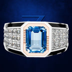 A men's statement ring featuring a large emerald-cut blue sapphire center stone, flanked by rows of clear pavé diamonds on a silver-toned band with a rose gold inlay.