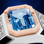 A close-up of a ring featuring a large rectangular blue gemstone in a rose gold bezel setting, with small clear stones on the band, shown against a dark blue background.