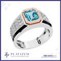 A platinum ring featuring a large emerald-cut light blue gemstone in a rose gold bezel, with a silver pavé-set band accented by black inlays. The brand logo 'PLATIZEM' is visible at the bottom.