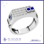 A platinum men's ring by Platinzem, featuring a rectangular top set with clear pavé stones, a blue hexagonal sapphire on the left, and a blue enamel geometric accent on the right, shown on a white background with a blue border.