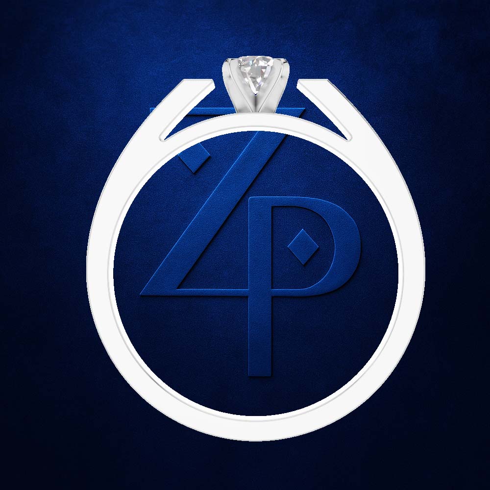 A white diamond ring with a round-cut clear gemstone, featuring a circular band with an embossed blue monogram design inside, set against a textured dark blue background.