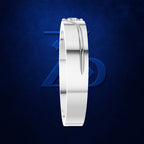 A polished silver band ring with a curved channel setting holding a single small clear gemstone, shown upright against a dark blue textured background with a subtle blue geometric logo behind it.