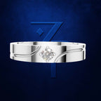 A polished silver-toned band ring with a single round brilliant-cut diamond set in a floral halo, presented against a textured dark blue background with a large stylized blue number 7 behind it.