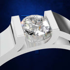A close-up studio render of a diamond ring with a large round brilliant-cut center stone in a white metal setting, shown against a deep blue background.