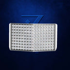 A rectangular LED wall light fixture with a silver metal frame, featuring a split design with rows of clear LED lenses on the left and a solid transparent panel on the right, set against a textured dark blue background with a subtle blue geometric logo.