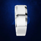 A polished silver-toned band ring with a beveled edge, shown from a side profile on a textured dark blue background.