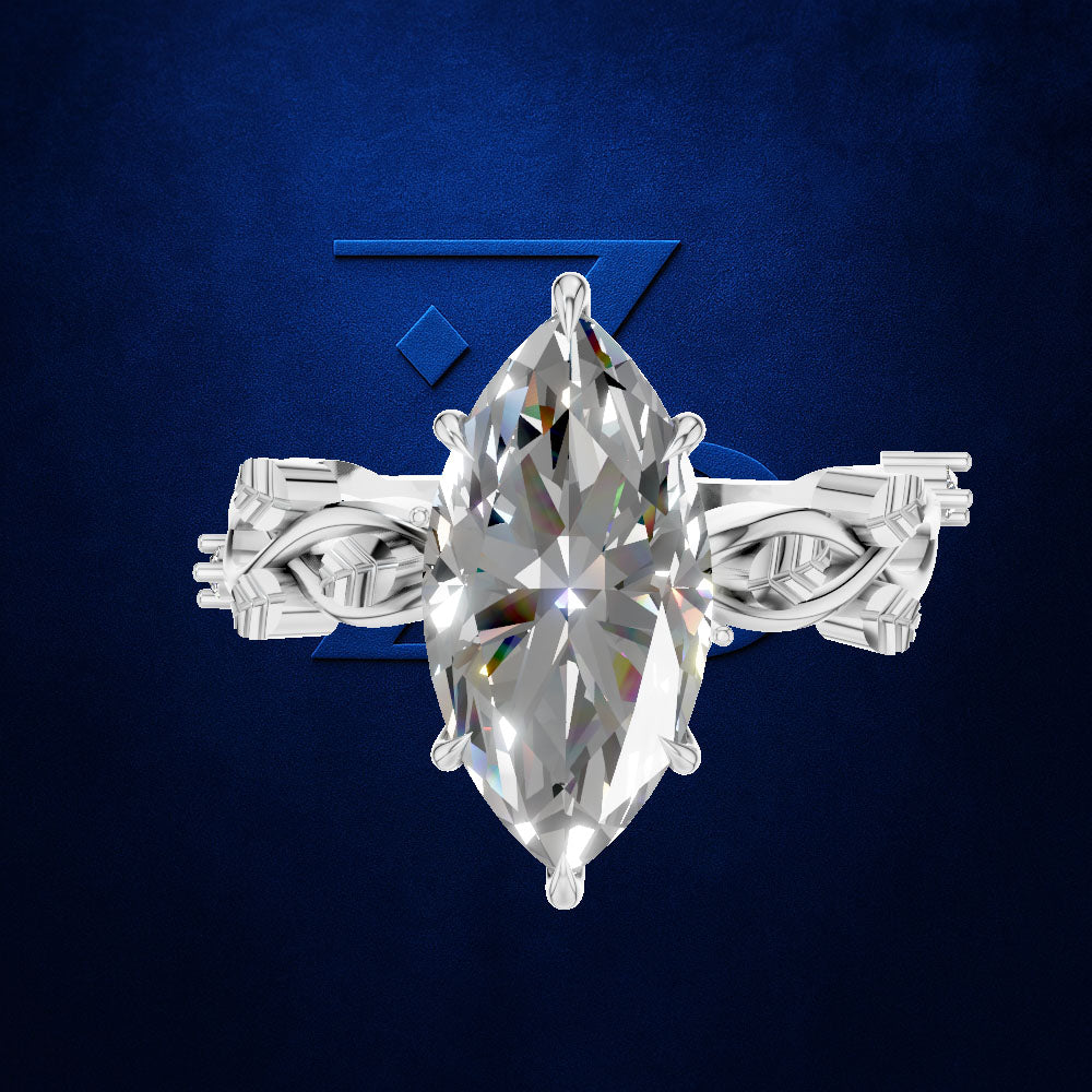 A silver-toned ring featuring a large marquise-cut clear gemstone in a prong setting, with ornate woven side bands, shown against a dark blue textured background.