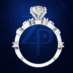 A silver-toned ring with a large round clear gemstone and sculpted geometric side details, centered on a dark blue textured background. The center of the ring features a circular blue insert with a stylized '4P' monogram.