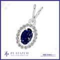 A silver pendant featuring a marquise-cut deep blue sapphire center stone surrounded by a halo of small clear stones, shown on a white background with the Platizem brand logo at the bottom.