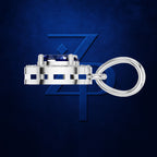 A silver-toned keychain featuring a rectangular bezel-set blue gemstone and a thick coiled ring, displayed against a textured dark blue background with a subtle stylized 'ZP' logo.