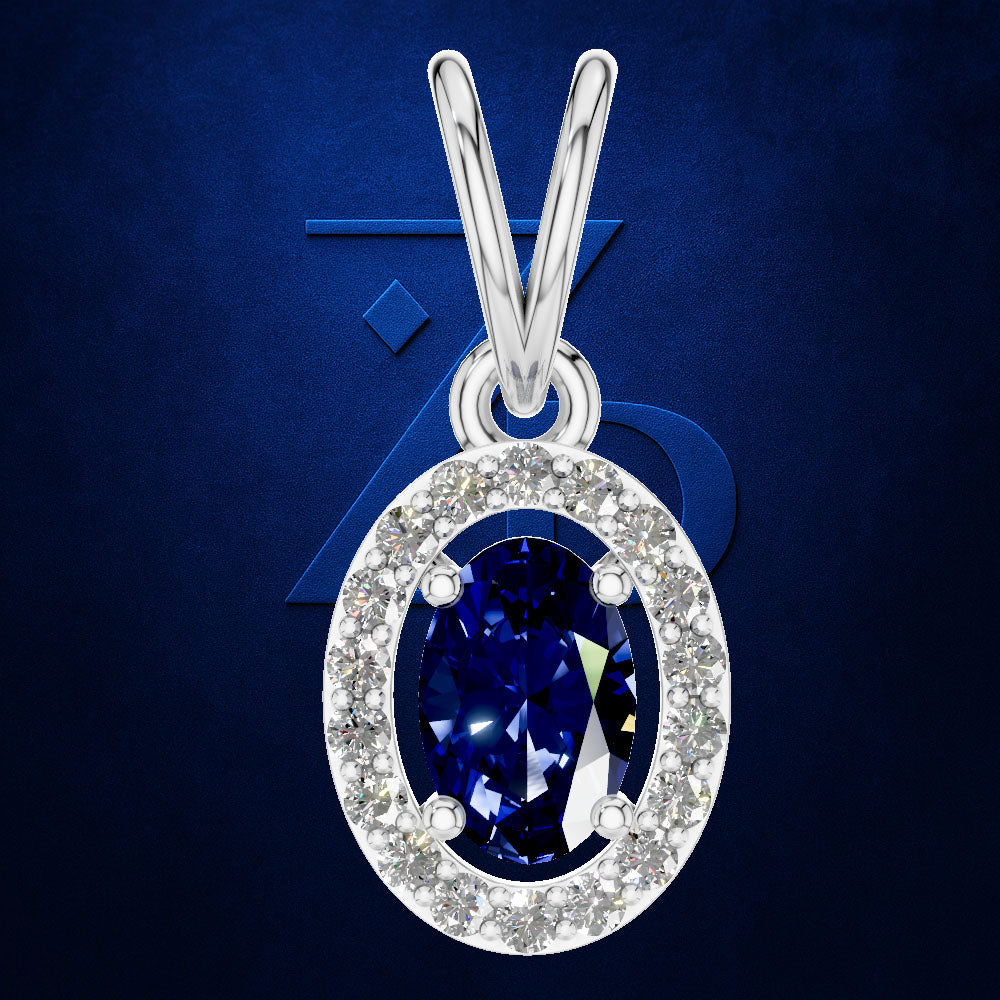 A silver oval pendant necklace featuring a deep blue sapphire center stone surrounded by a halo of small clear stones, set against a dark blue textured background.