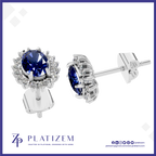 A pair of silver stud earrings with oval-cut deep blue gemstones and small clear accent stones, shown on a white background with the PLATIZEM brand logo at the bottom.