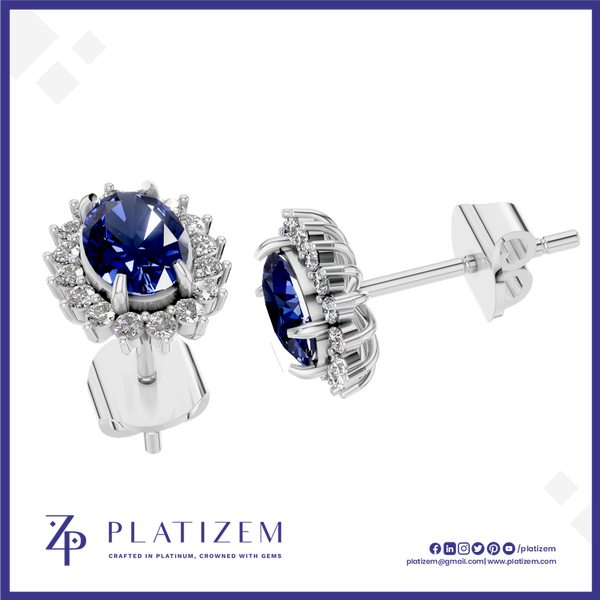 A pair of silver stud earrings with oval-cut deep blue gemstones and small clear accent stones, shown on a white background with the PLATIZEM brand logo at the bottom.