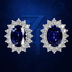 A pair of oval stud earrings featuring deep blue sapphires surrounded by clear round diamonds in a halo setting, presented on a textured dark blue background with a stylized '74' graphic.