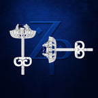 A pair of silver-toned floral stud earrings with deep blue gemstones, shown from both front and side angles against a textured dark blue background with a subtle stylized 'Z' logo.