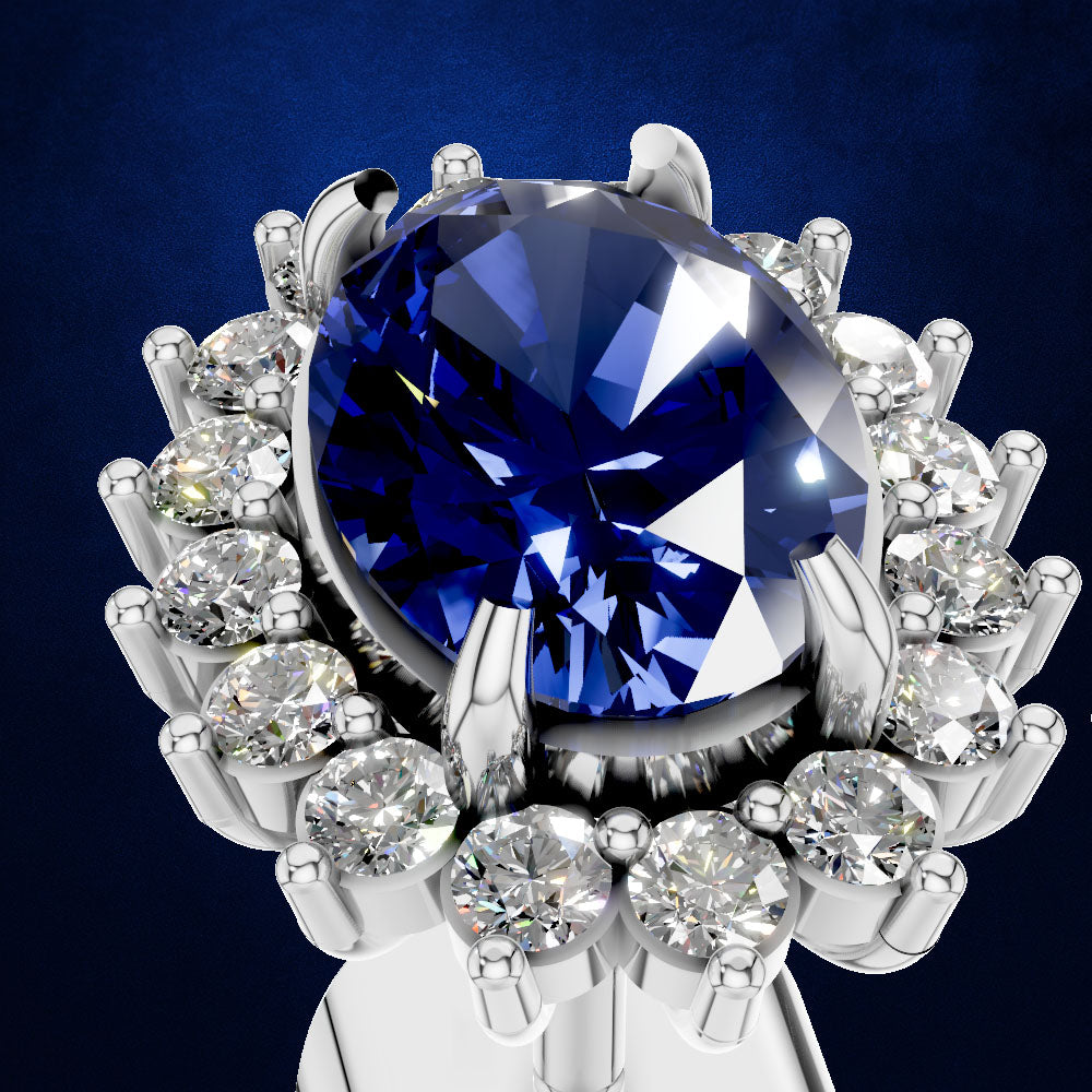 A close-up studio shot of a silver-toned ring featuring a large oval deep blue gemstone surrounded by a halo of round clear stones, set against a dark blue gradient background.