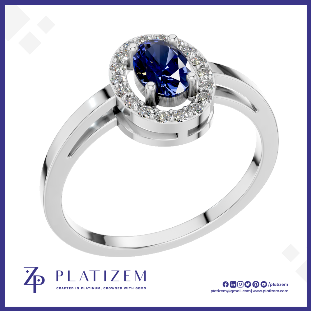 A silver-plated halo ring featuring a round-cut deep blue sapphire center stone surrounded by a halo of small clear stones, shown on a white background with the Platiszem brand logo at the bottom.