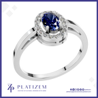 A silver-plated halo ring featuring a round-cut deep blue sapphire center stone surrounded by a halo of small clear stones, shown on a white background with the Platiszem brand logo at the bottom.
