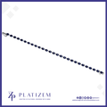 A silver-toned tennis bracelet with dark blue oval-cut stones, shown diagonally on a white background with the brand name 'PLATIZEM' at the bottom.