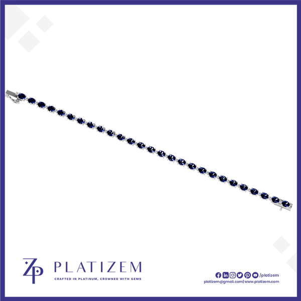 A silver-toned tennis bracelet with dark blue oval-cut stones, shown diagonally on a white background with the brand name 'PLATIZEM' at the bottom.