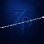 A silver chain link accessory shown diagonally across a textured dark blue background with a large embossed stylized 'ZP' logo.