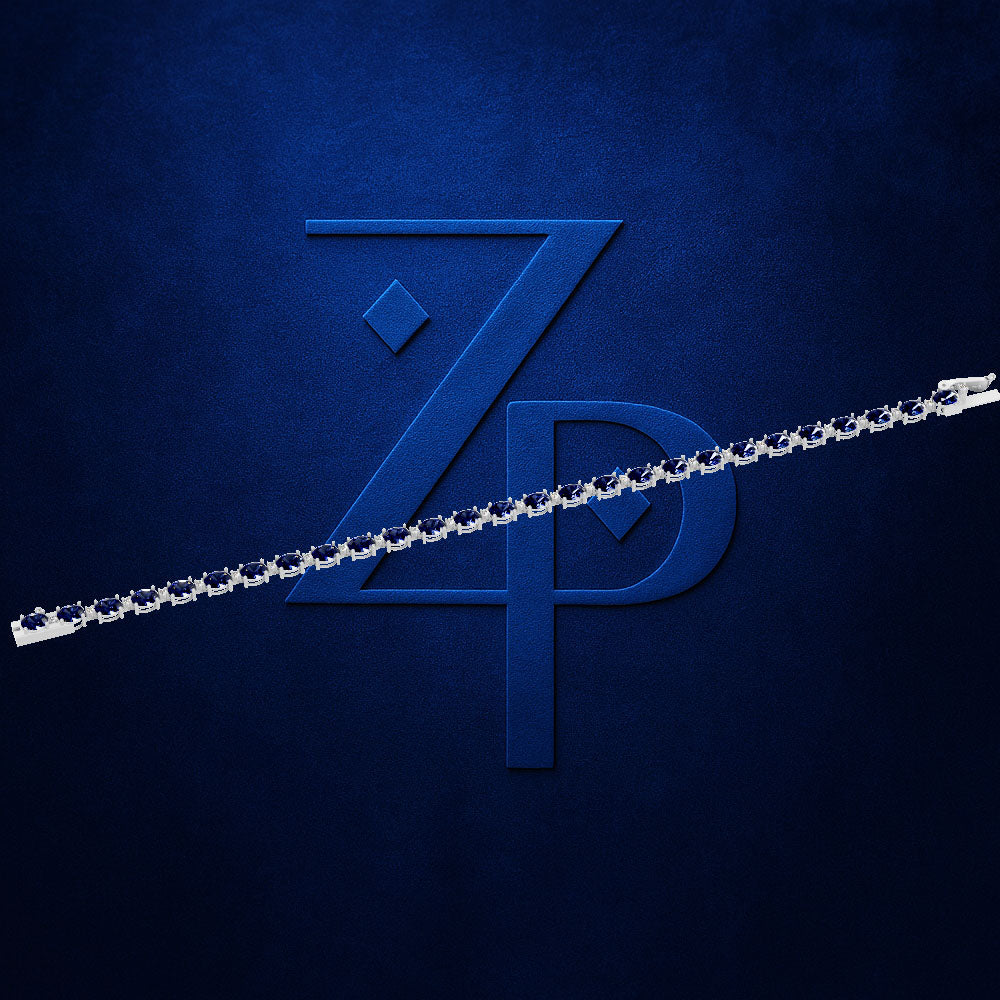 A silver chain link accessory shown diagonally across a textured dark blue background with a large embossed stylized 'ZP' logo.