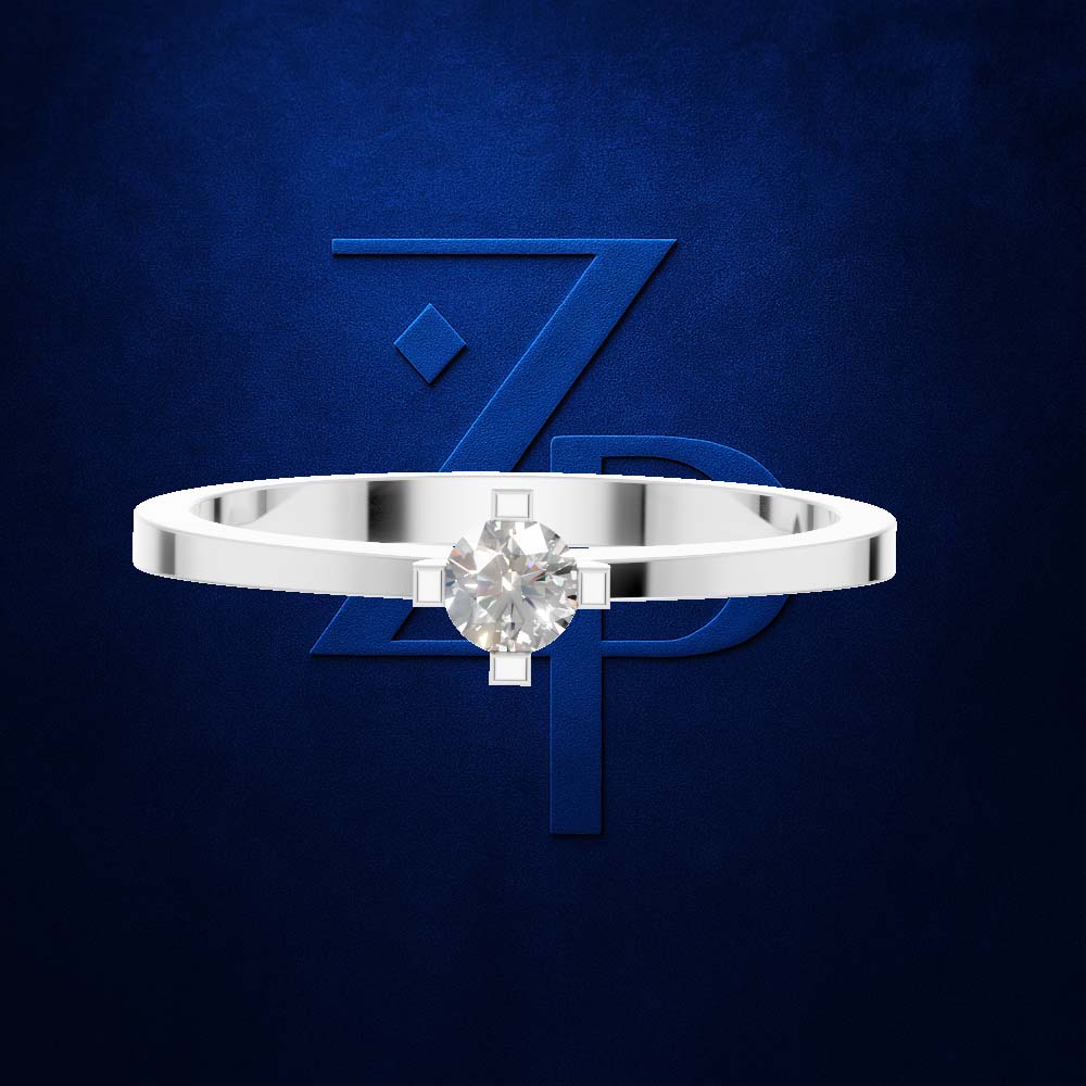 A silver-toned solitaire ring with a round brilliant-cut diamond set in a four-prong setting, presented against a textured dark blue background with a stylized blue 'ZPD' logo.