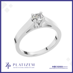 A classic solitaire engagement ring with a round brilliant-cut diamond set in a polished white gold or platinum band, presented on a white background with a blue border and the Platizem brand logo at the bottom.