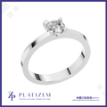 A classic solitaire engagement ring with a round brilliant-cut diamond set in a polished white gold or platinum band, presented on a white background with a blue border and the Platizem brand logo at the bottom.