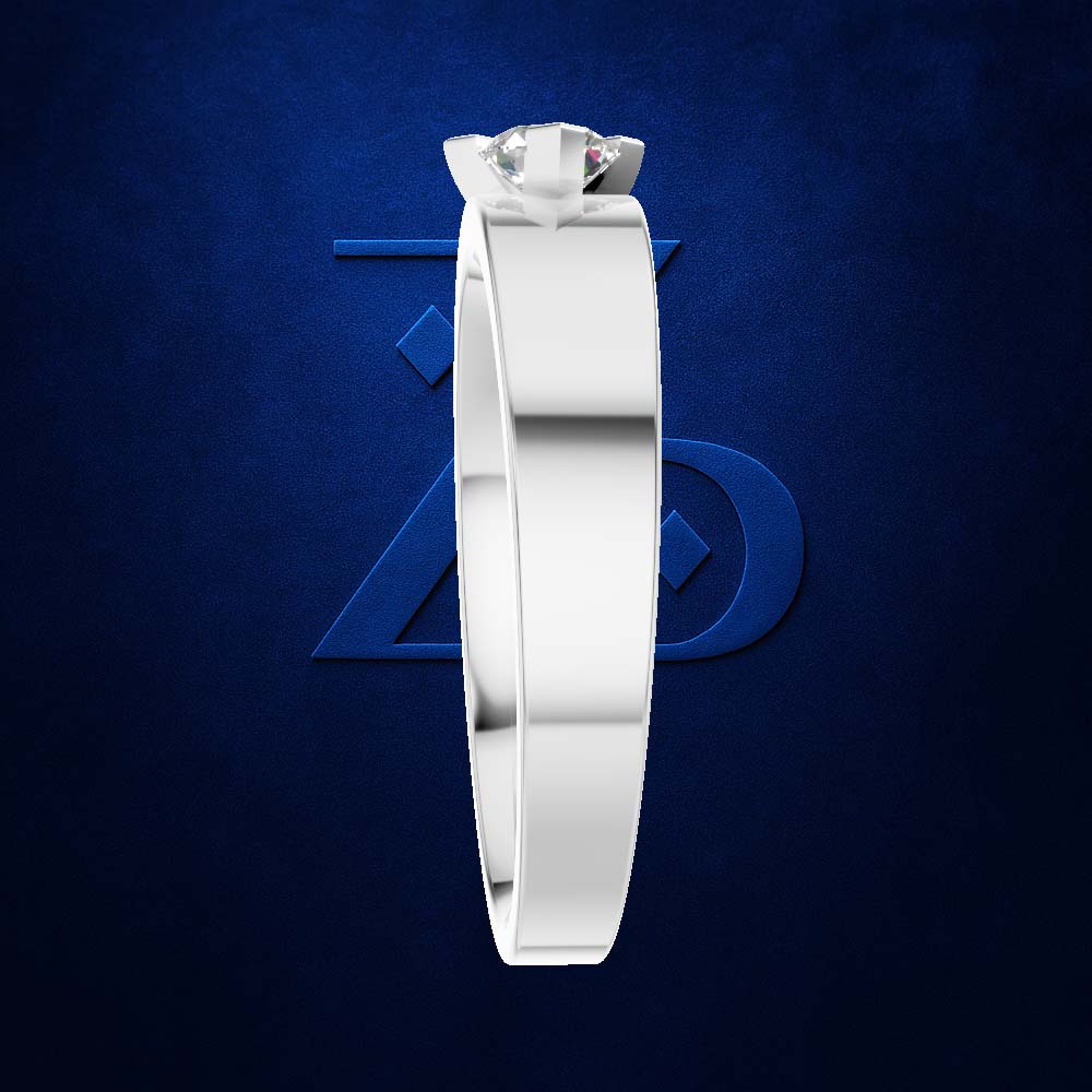 A white gold or platinum solitaire ring with a clear gemstone, shown from the side against a textured dark blue background with a subtle geometric logo.