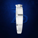 A white gold or platinum solitaire ring with a clear gemstone, shown from the side against a textured dark blue background with a subtle geometric logo.