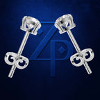 A pair of silver-toned stud earrings with round-cut clear gemstones and decorative scroll backings, displayed on a dark blue textured background with a large blue monogram logo behind them.