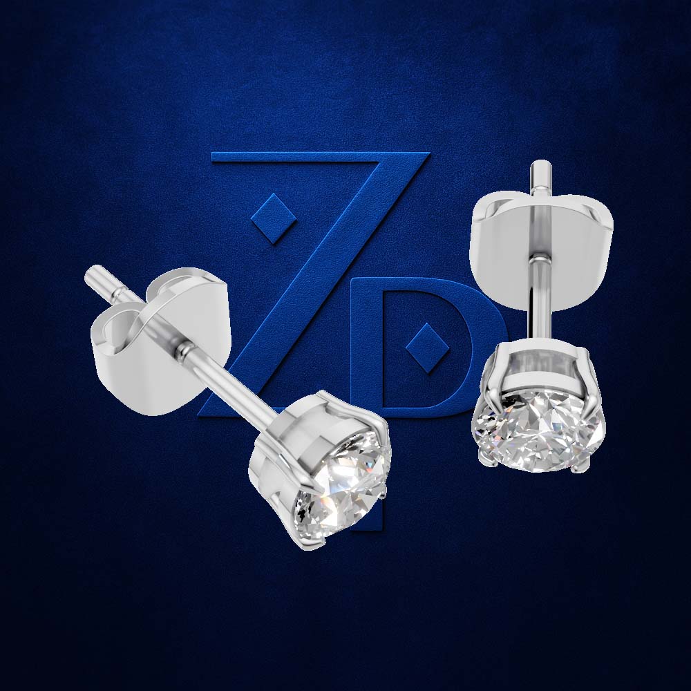 A pair of silver stud earrings with round clear gemstones, shown from both front and back views against a textured dark blue background with a stylized 'ZPD' logo.
