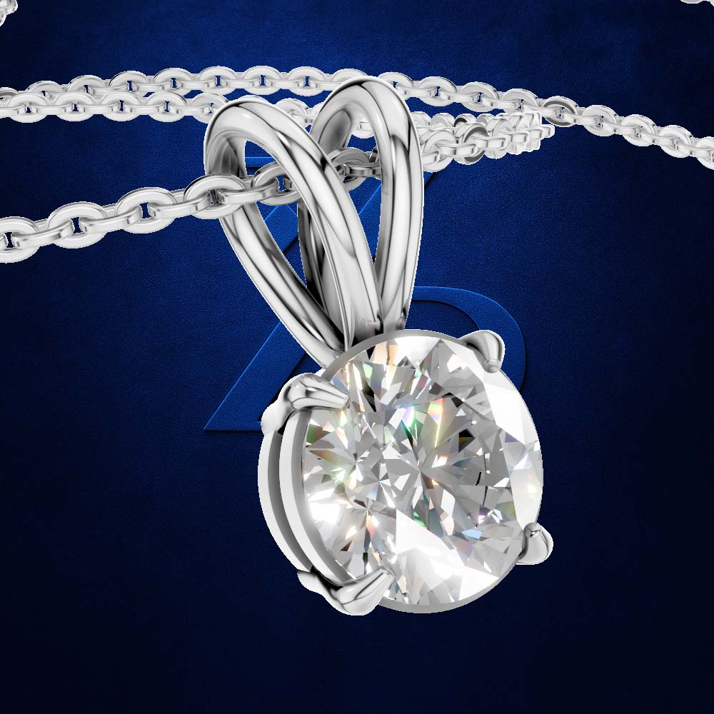 A silver-toned round-cut diamond pendant necklace with a matching chain, shown against a dark blue textured background.