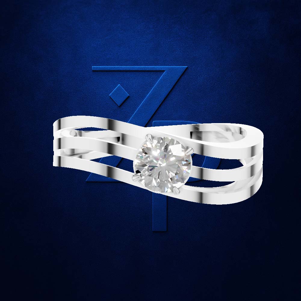 A silver-toned triple-band ring with a round-cut clear gemstone, presented against a textured dark blue background with a stylized blue 'Z' logo.