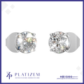 A pair of round-cut solitaire stud earrings in silver-toned metal with clear gemstones, shown on a white background with the PLATIZEM brand logo at the bottom.