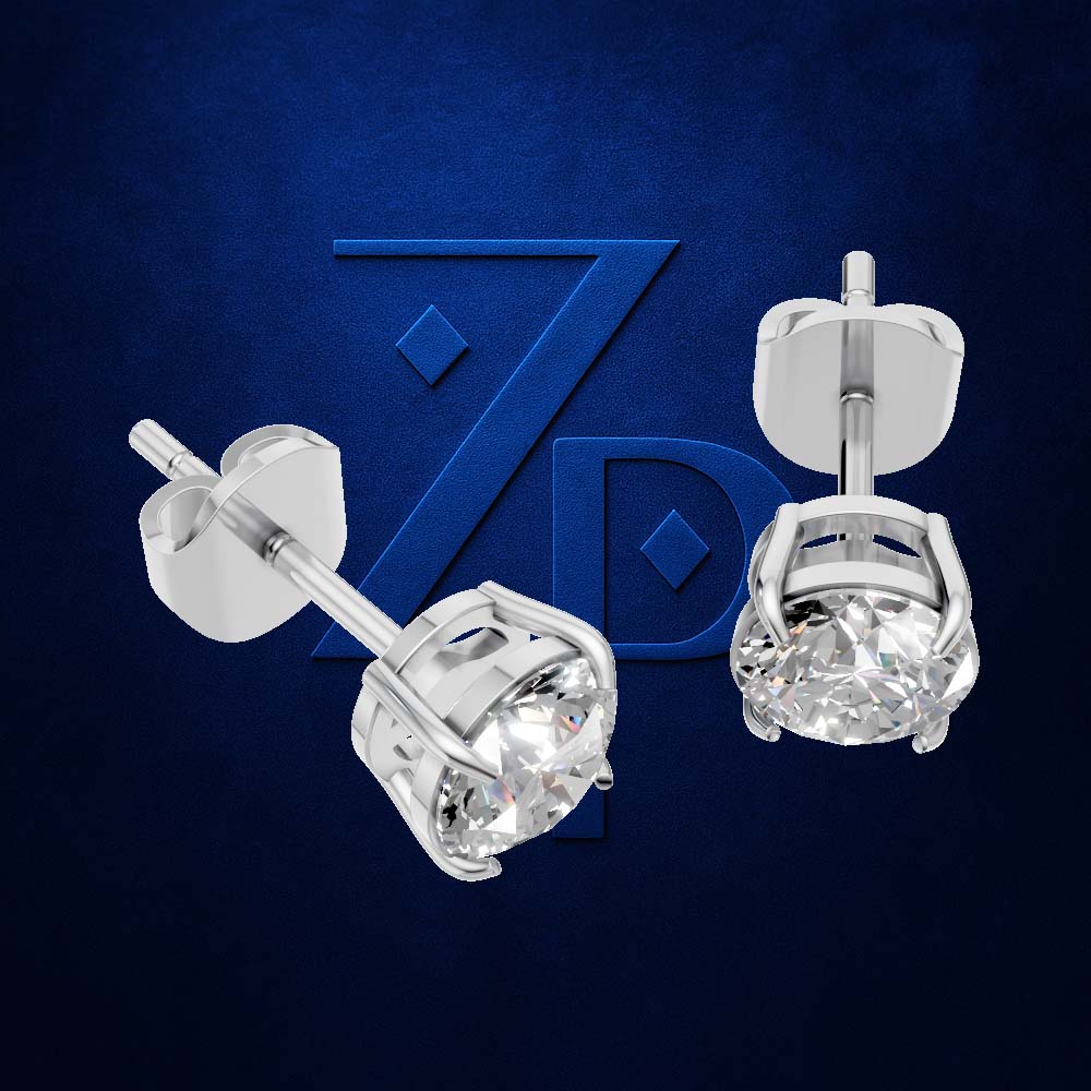 A pair of silver stud earrings with clear round-cut gemstones, shown from front and side angles against a dark blue textured background with a stylized 'ZPD' logo.