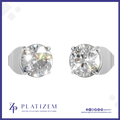 A pair of round-cut solitaire stud earrings in a silver-toned metal setting, shown on a white background with the brand name PLATIZEM at the bottom.