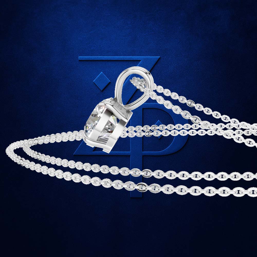 A silver-toned pendant necklace with a faceted clear gemstone in a bezel setting, shown on a dark blue textured background with a faint blue logo behind it.